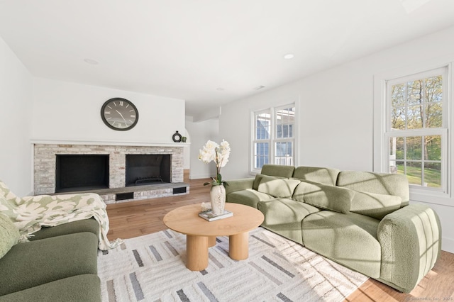 82 Indian Hill Rd, Wilton, CT 06897 - living room with a fireplace with raised hearth, wood finished floors, plenty of natural light, and baseboards