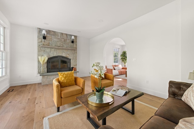 82 Indian Hill Rd, Wilton, CT 06897 - living area featuring healthy amount of natural light, arched walkways, light wood-style floors, and baseboards