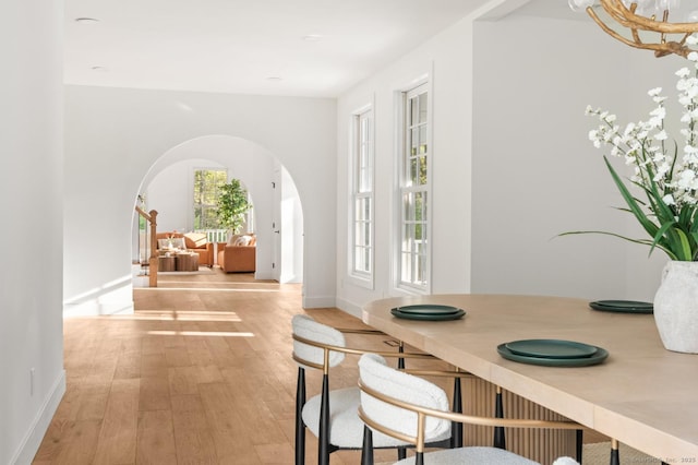 82 Indian Hill Rd, Wilton, CT 06897 - dining area featuring arched walkways, light wood-style flooring, and baseboards