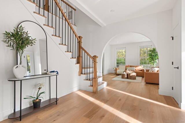 82 Indian Hill Rd, Wilton, CT 06897 - foyer entrance with arched walkways, wood finished floors, stairway, and baseboards