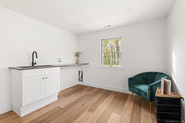 82 Indian Hill Rd, Wilton, CT 06897 - bar area featuring a sink, light wood finished floors, and baseboards