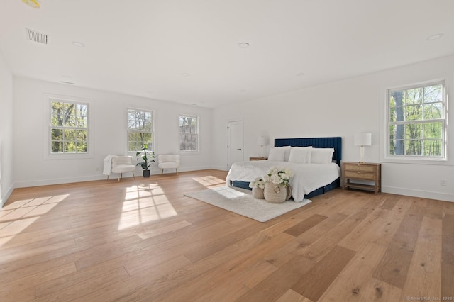 82 Indian Hill Rd, Wilton, CT 06897 - unfurnished bedroom featuring light wood finished floors, multiple windows, and baseboards