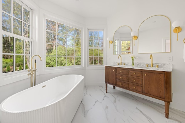82 Indian Hill Rd, Wilton, CT 06897 - bathroom featuring marble finish flooring, double vanity, a freestanding bath, and baseboards