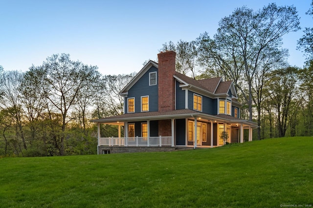 82 Indian Hill Rd, Wilton, CT 06897 - rear view of property featuring covered porch, a yard, and a chimney