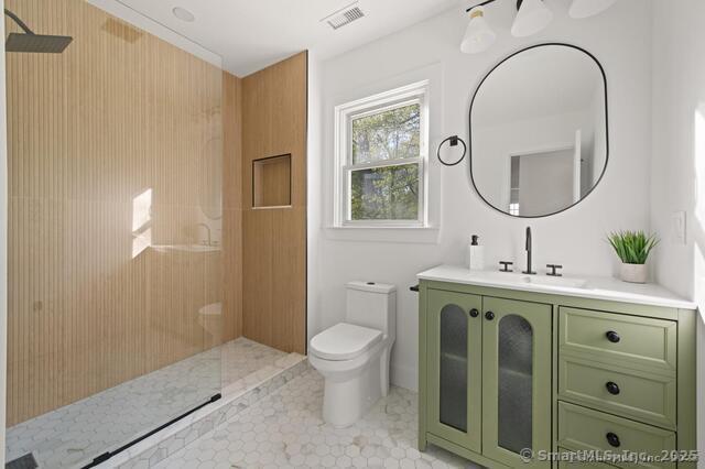 82 Indian Hill Rd, Wilton, CT 06897 - bathroom featuring walk in shower, toilet, vanity, and tile patterned flooring