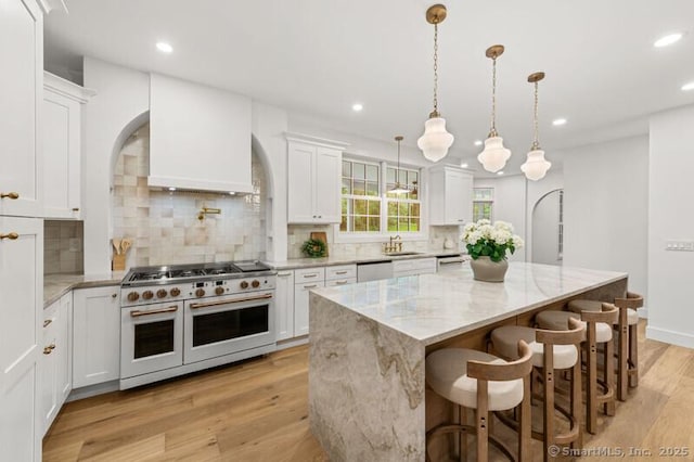 82 Indian Hill Rd, Wilton, CT 06897 - kitchen featuring white appliances, white cabinetry, light wood-style floors, light stone countertops, and recessed lighting