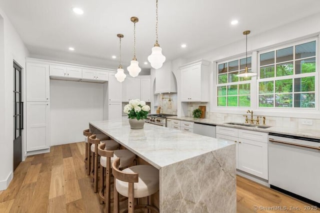 82 Indian Hill Rd, Wilton, CT 06897 - kitchen with appliances with stainless steel finishes, a sink, white cabinetry, recessed lighting, and decorative backsplash