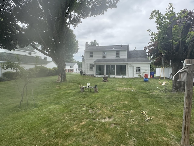34 Knollwood Rd, East Hartford, CT 06118 - back of house featuring a sunroom, a lawn, and a chimney