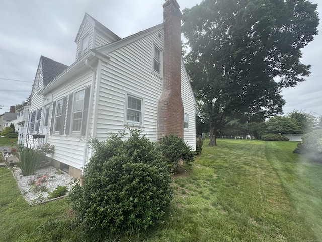 34 Knollwood Rd, East Hartford, CT 06118 - view of property exterior with a chimney and a lawn