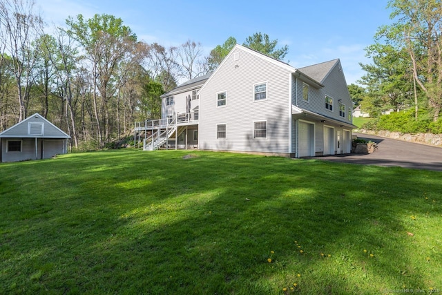 95 Pepperidge Cir, Stratford, CT 06614 - rear view of property with stairs, an attached garage, a deck, a lawn, and driveway
