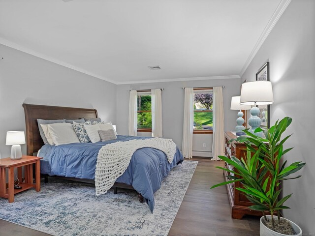 95 Pepperidge Cir, Stratford, CT 06614 - bedroom with ornamental molding, a baseboard heating unit, wood finished floors, and visible vents