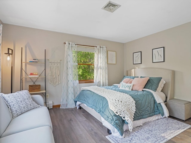 95 Pepperidge Cir, Stratford, CT 06614 - bedroom featuring baseboards, a baseboard heating unit, wood finished floors, and visible vents