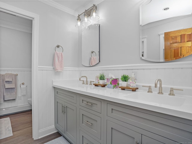 95 Pepperidge Cir, Stratford, CT 06614 - full bathroom with crown molding, wood finished floors, toilet, baseboard heating, and a sink