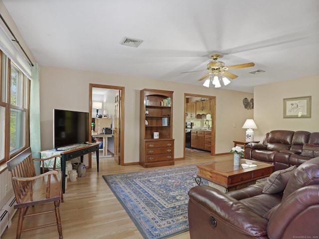 95 Pepperidge Cir, Stratford, CT 06614 - living room with a ceiling fan, a baseboard heating unit, light wood finished floors, and visible vents