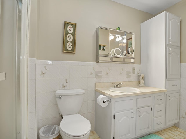 95 Pepperidge Cir, Stratford, CT 06614 - bathroom with vanity, wainscoting, toilet, and tile walls