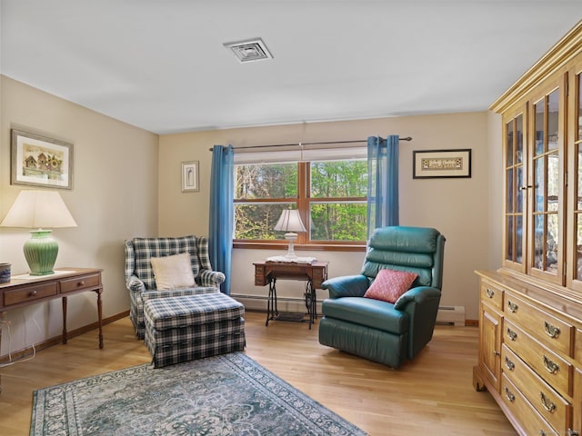 95 Pepperidge Cir, Stratford, CT 06614 - living area with light wood-style floors, a baseboard radiator, and visible vents