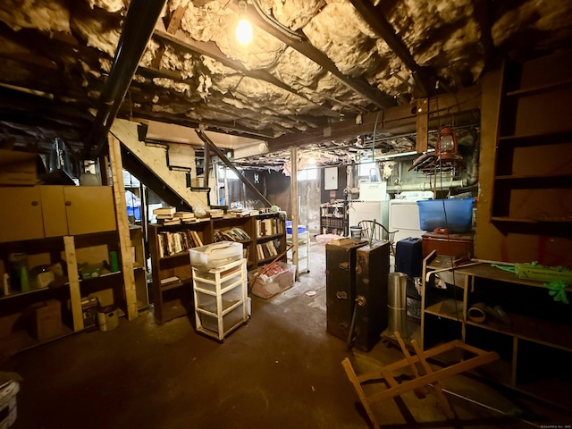 unfinished below grade area with stairway and washing machine and clothes dryer