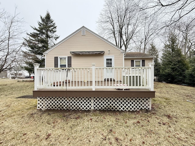 back of property featuring a lawn and a deck