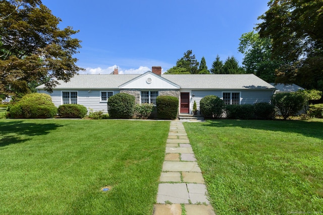single story home featuring a chimney and a front lawn