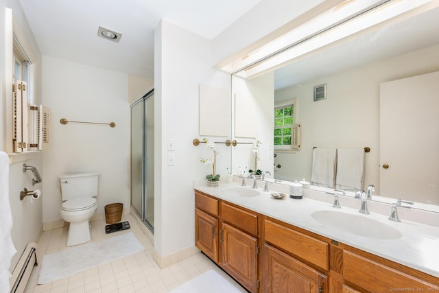full bath featuring a sink, a stall shower, a baseboard heating unit, and toilet