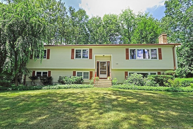 478 Alpom Dr, Orange, CT 06477 - split foyer home with a chimney, entry steps, and a front yard