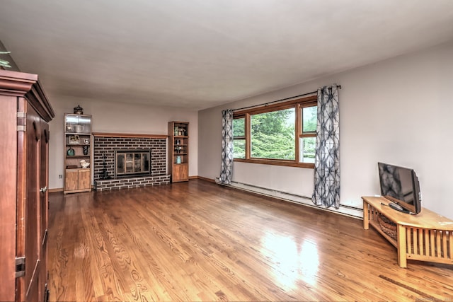 478 Alpom Dr, Orange, CT 06477 - unfurnished living room featuring wood finished floors, baseboard heating, and a brick fireplace