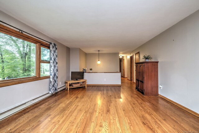 478 Alpom Dr, Orange, CT 06477 - unfurnished living room featuring light wood-style flooring, a baseboard heating unit, and baseboards