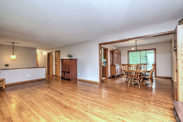 478 Alpom Dr, Orange, CT 06477 - living area with light wood finished floors, baseboards, and a chandelier