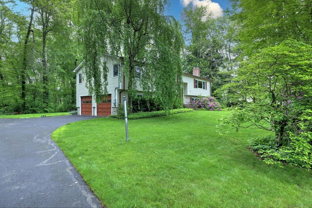 478 Alpom Dr, Orange, CT 06477 - view of front of property featuring a chimney, driveway, a garage, and a front lawn