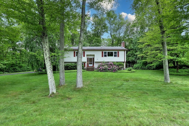 478 Alpom Dr, Orange, CT 06477 - bi-level home featuring a chimney, entry steps, and a front yard