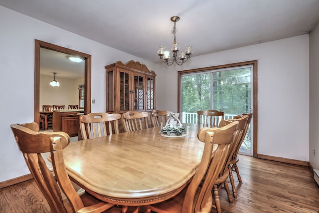 478 Alpom Dr, Orange, CT 06477 - dining area with a chandelier, light wood-style flooring, and baseboards