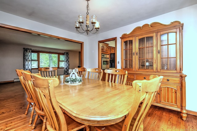 478 Alpom Dr, Orange, CT 06477 - dining room with a chandelier, wood finished floors, and a baseboard heating unit