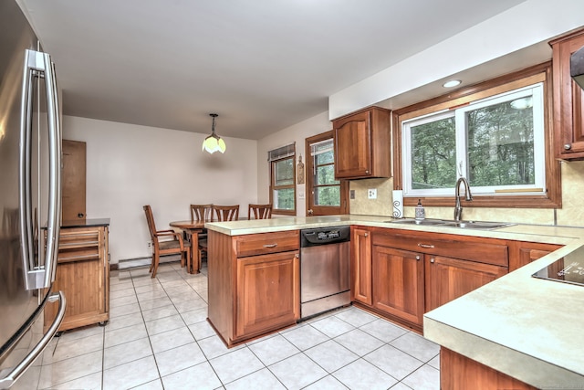 478 Alpom Dr, Orange, CT 06477 - kitchen featuring stainless steel appliances, a sink, a peninsula, baseboard heating, and brown cabinetry