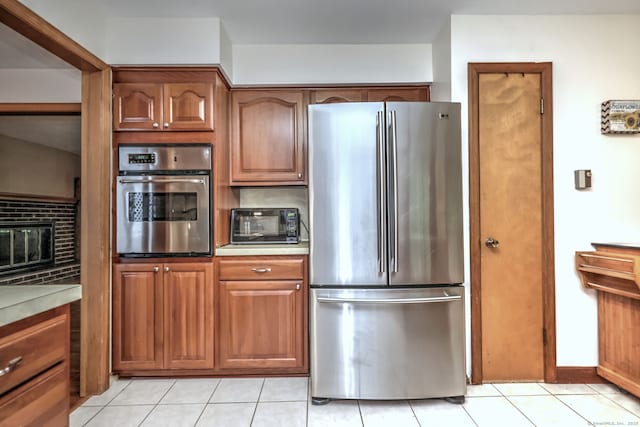 478 Alpom Dr, Orange, CT 06477 - kitchen with appliances with stainless steel finishes, light countertops, decorative backsplash, and light tile patterned floors