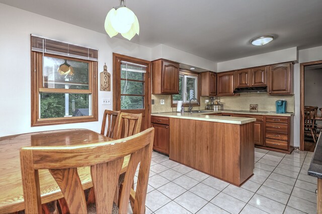 478 Alpom Dr, Orange, CT 06477 - kitchen featuring under cabinet range hood, a peninsula, light countertops, and tasteful backsplash