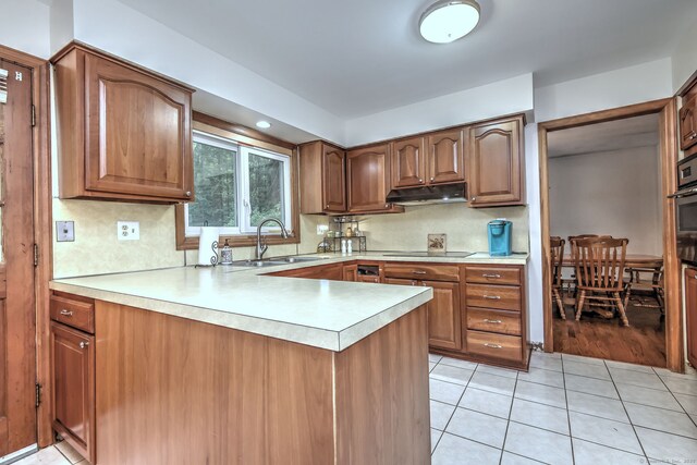 478 Alpom Dr, Orange, CT 06477 - kitchen featuring a sink, under cabinet range hood, black electric stovetop, a peninsula, and light countertops