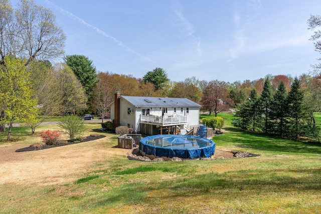 101 Michele Dr, Somers, CT 06071 - back of house with a lawn, a deck, a chimney, and a covered pool