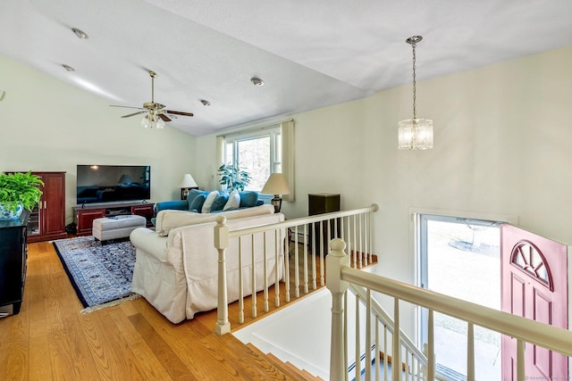 101 Michele Dr, Somers, CT 06071 - living area featuring ceiling fan with notable chandelier, wood finished floors, and vaulted ceiling
