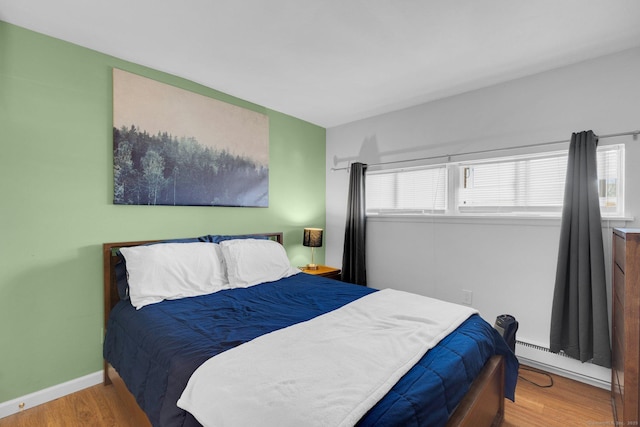 257 W Walk Unit 257, West Haven, CT 06516 - bedroom with baseboards, a baseboard heating unit, and wood finished floors