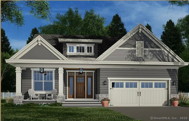 craftsman-style house featuring a front lawn, a porch, and driveway