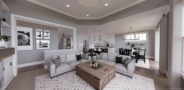 living room featuring baseboards, ornamental molding, recessed lighting, and wood finished floors
