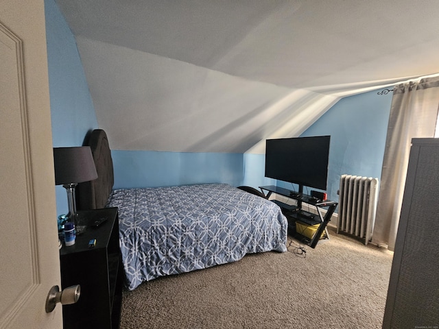 carpeted bedroom with radiator and lofted ceiling