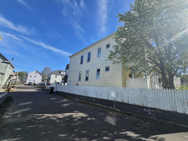 view of home's exterior featuring fence and a residential view