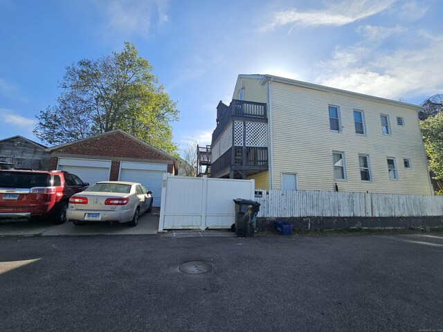 4 Tinker Ct, New London, CT 06320 - view of side of property featuring fence, an outbuilding, and a detached garage