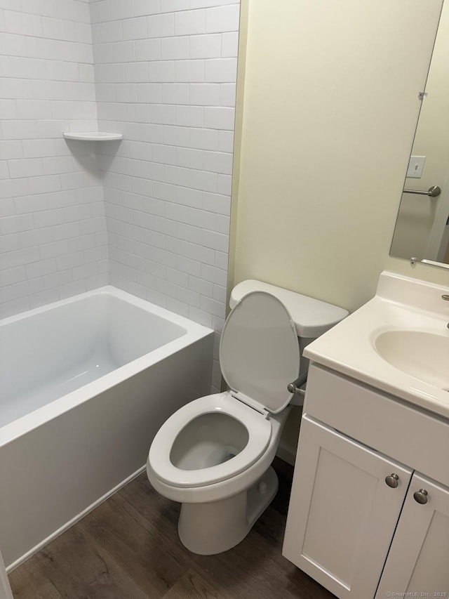 full bath featuring vanity, shower / bathing tub combination, toilet, and wood finished floors