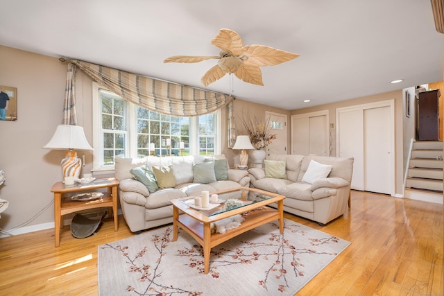living room with recessed lighting, ceiling fan, light wood-style flooring, and stairway