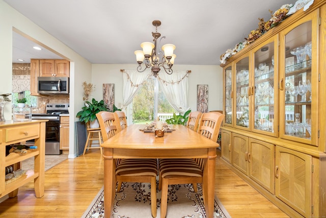 dining room featuring recessed lighting, a chandelier, and light wood finished floors