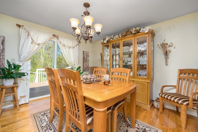 dining space featuring an inviting chandelier and light wood-style flooring