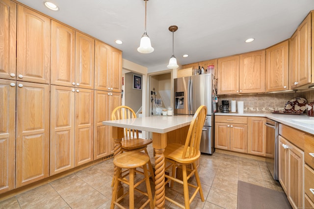 kitchen featuring light countertops, stainless steel appliances, recessed lighting, and backsplash