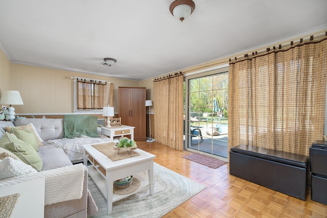 living room with crown molding and baseboards